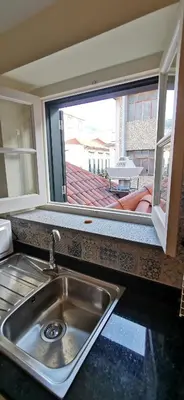 a kitchen with a sink and a large window at Franciscus 2c in Funchal