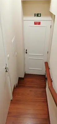 a hallway with a white door and a wooden floor at Franciscus 2c in Funchal