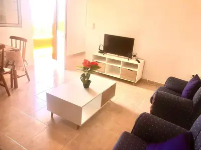 a living room with a tv and a coffee table at Casa Vista Mar -2 bedrooms,fantastic Seaview in Estreito da Calheta