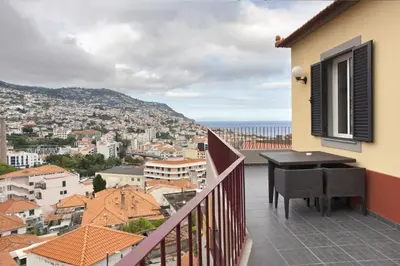a balcony with a table and a view of a city at Arrifes View 2 Funchal by Rentallido in Funchal