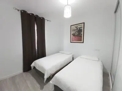 a bedroom with two beds and a window at Arrifes View 2 Funchal by Rentallido in Funchal