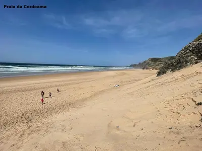 a group of people walking on a beach at Elm Apartament in Sagres