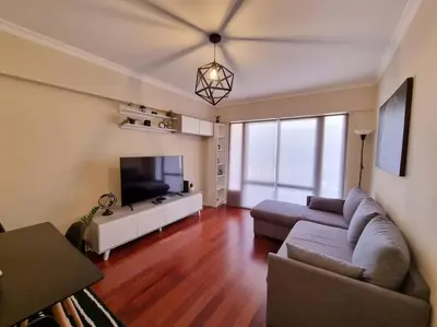 a living room with a couch and a flat screen tv at Olimpia Gardens View by Rentallido in Funchal