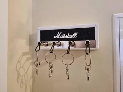 a group of keys hanging from a sign on a wall at Olimpia Gardens View by Rentallido in Funchal