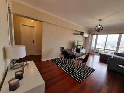 a living room with a table and a couch at Olimpia Gardens View by Rentallido in Funchal
