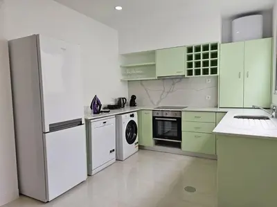 a kitchen with green cabinets and white appliances at Caminho da Achada Apartment Funchal by Rentallido in Funchal