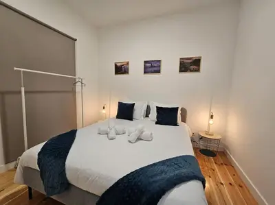 a bedroom with a large white bed with two pillows at Caminho da Achada Apartment Funchal by Rentallido in Funchal