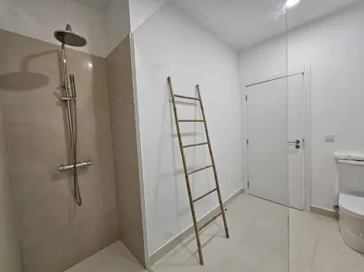 a ladder in a bathroom with a shower and a toilet at Caminho da Achada Apartment Funchal by Rentallido in Funchal