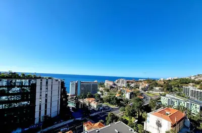 a view of a city with the ocean in the background at Infante Sunset Funchal by Rentallido in Funchal