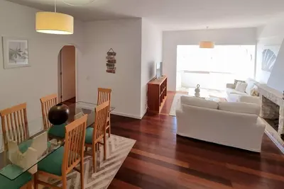 a living room with a couch and a table and chairs at Infante Sunset Funchal by Rentallido in Funchal