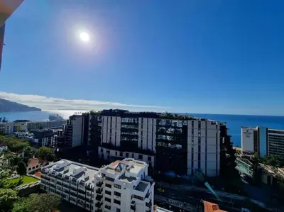 a view of a city with buildings and the ocean at Infante Sunset Funchal by Rentallido in Funchal