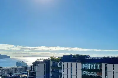 a view of a city with buildings and the ocean at Infante Sunset Funchal by Rentallido in Funchal
