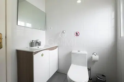 a white bathroom with a toilet and a sink at Esterinha's Ocean Apartment by GALMI in Jardim do Mar