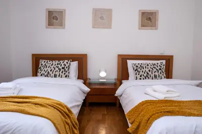 a bedroom with two beds with towels on them at Elsa's Place II in Funchal