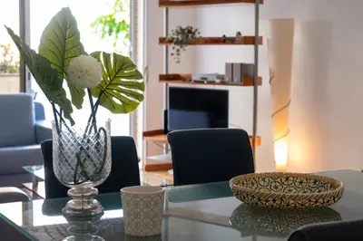 a glass vase with a plant on a glass table at Elsa's Place II in Funchal
