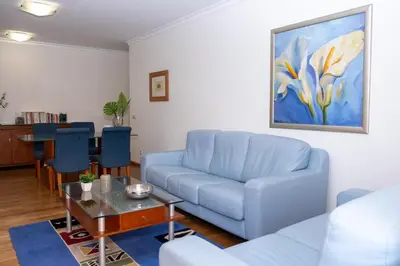 a living room with a blue couch and a table at Elsa's Place II in Funchal
