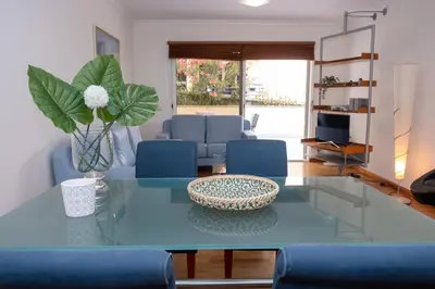 a living room with a blue table and blue chairs at Elsa's Place II in Funchal
