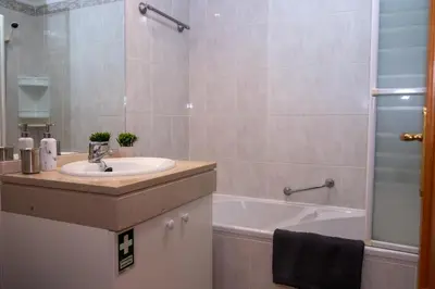 a bathroom with a sink and a bath tub at Elsa's Place II in Funchal