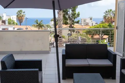 a patio with two chairs and an umbrella at Elsa's Place II in Funchal
