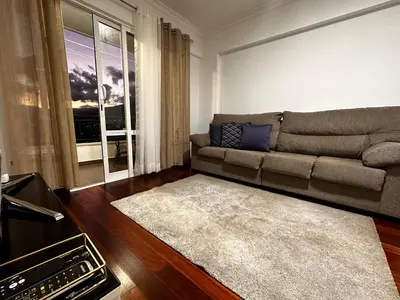 a living room with a couch and a window at SÃO GONÇALO APARTAMENTO in Funchal