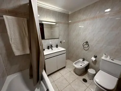 a bathroom with a toilet and a sink and a bath tub at SÃO GONÇALO APARTAMENTO in Funchal
