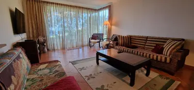 a living room with a couch and a coffee table at Sunny Arco Retreat in Arco da Calheta
