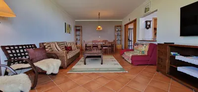 a living room with couches and a dining room at Sunny Arco Retreat in Arco da Calheta
