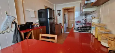 a kitchen with a black refrigerator and a red counter top at Sunny Arco Retreat in Arco da Calheta