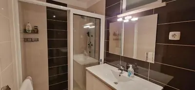 a bathroom with a sink and a shower at Sunny Arco Retreat in Arco da Calheta