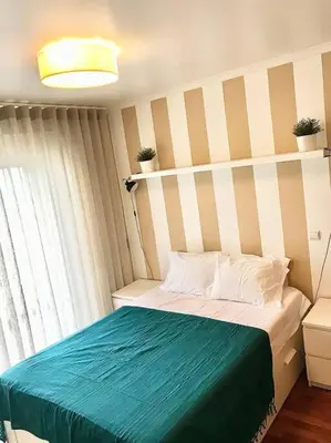 a bedroom with a bed with a blue blanket at Gemini Apartment by AM in Funchal