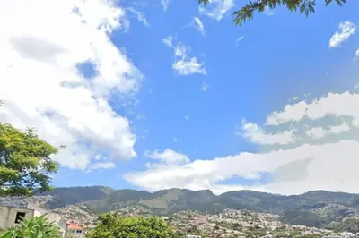 a view of a city with mountains in the background at Gemini Apartment by AM in Funchal