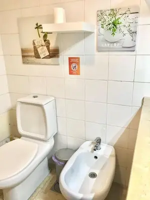 a white bathroom with a toilet and a sink at Gemini Apartment by AM in Funchal