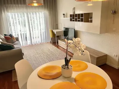 a living room with a table with two plates on it at Gemini Apartment by AM in Funchal