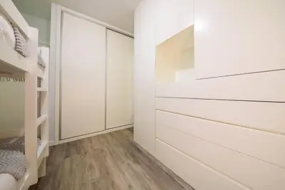 a room with white drawers and a closet at Casa da Clara by MTH in Caniço