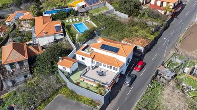 an aerial view of a house with a swimming pool at De Casa Villa by GALMI in Estreito da Calheta