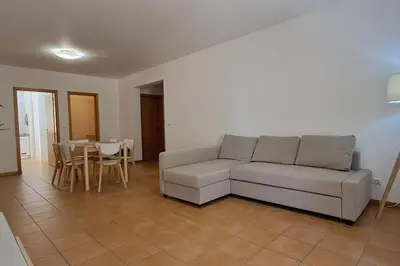 a living room with a couch and a table at Casa das Lombas in Vila Baleira