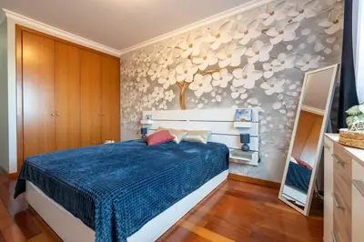 a bedroom with a blue bed and a wall with shells at Comfy & Joyful Oceanview Retreat in Caniço