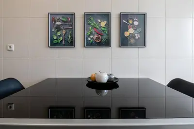 a wall with four pictures of vegetables on it at Comfy & Joyful Oceanview Retreat in Caniço