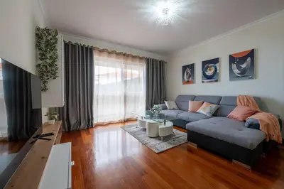 a living room with a couch and a table at Comfy & Joyful Oceanview Retreat in Caniço