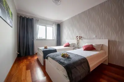 a bedroom with two beds and a window at Comfy & Joyful Oceanview Retreat in Caniço