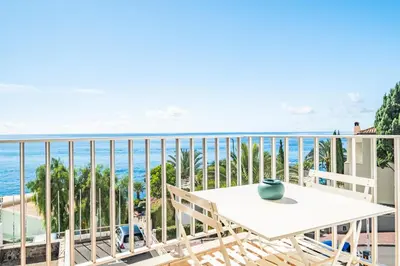 a balcony with a table and a view of the ocean at Studio Mar - By WeHost in Funchal
