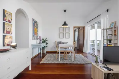 a living room with a table and a tv at Casa da Angela - By WeHost in Funchal