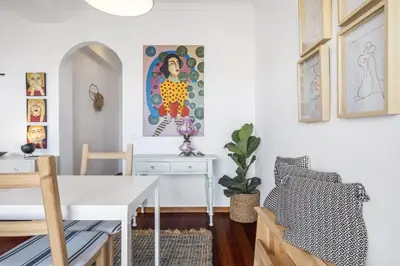 a dining room with a white table and a desk at Casa da Angela - By WeHost in Funchal