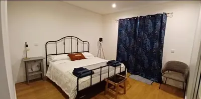 a bedroom with a bed and a chair at Quinta Sol II Sea in Camacha