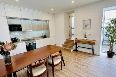 a kitchen with a wooden table and a dining room at Casa Branca Apartment in Funchal in Funchal