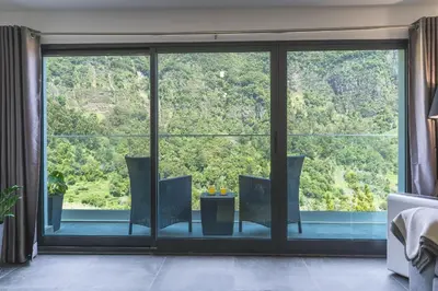a room with a large window with chairs and a table at Mystic Mountain by Atlantic Holiday in São Vicente