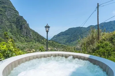 a tub with water in it with mountains in the background at Mystic Mountain by Atlantic Holiday in São Vicente