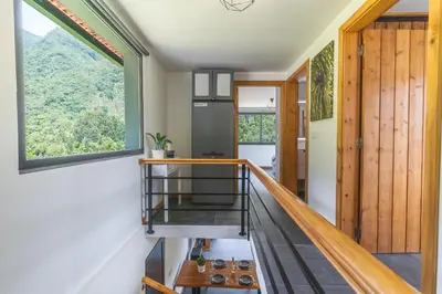 a staircase in a house with a window at Mystic Mountain by Atlantic Holiday in São Vicente