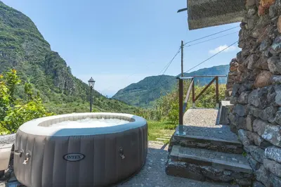 a hot tub on the side of a building with mountains at Mystic Mountain by Atlantic Holiday in São Vicente