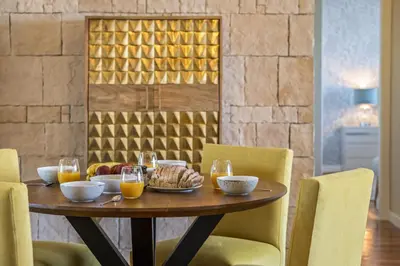 a wooden table with food and glasses of orange juice at Hideaway Apartment by Homie in Caniço